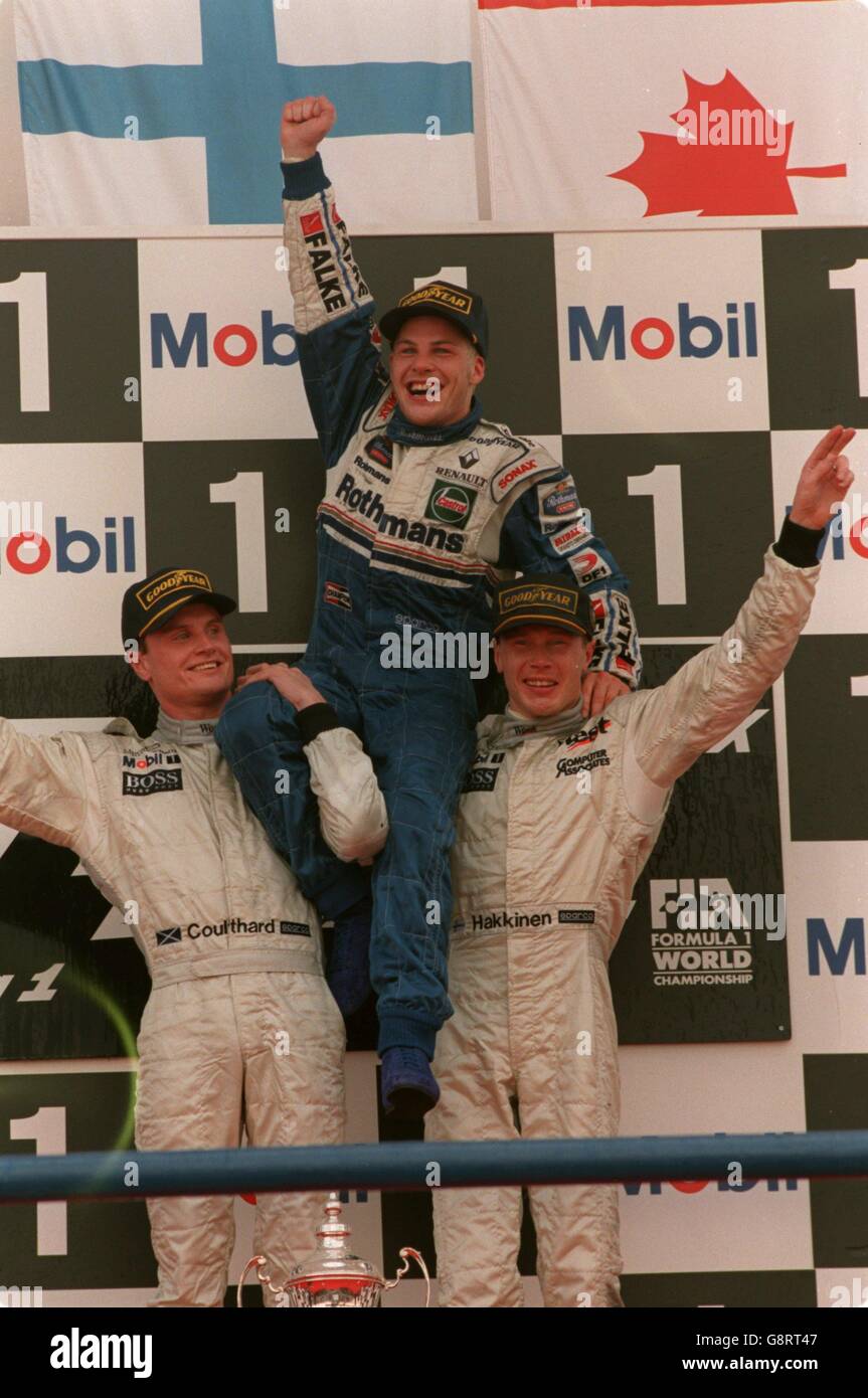 David Coulthard (left) and Mika Hakkinen (right) lift the new world champion  Jacques Villeneuve (centre) on their shoulders Stock Photo - Alamy