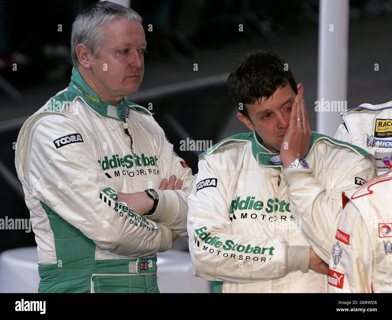 Rally driver Mark Higgins (R) wipes way a tear watched by his co-driver Bryan Thomas (L) after observing a minutes silence in the Millennium stadium for the death of Michael Park at the end of the Rally Britain in Wales, Sunday September 18, 2005. Markko Martin's co-driver Park died in a crash in their Peugeot 307 WRC at the Margam Park stage of the rally. See PA story AUTO Rally Death. PRESS ASSOCIATION Photo. Photo credit should read: PA. Stock Photo