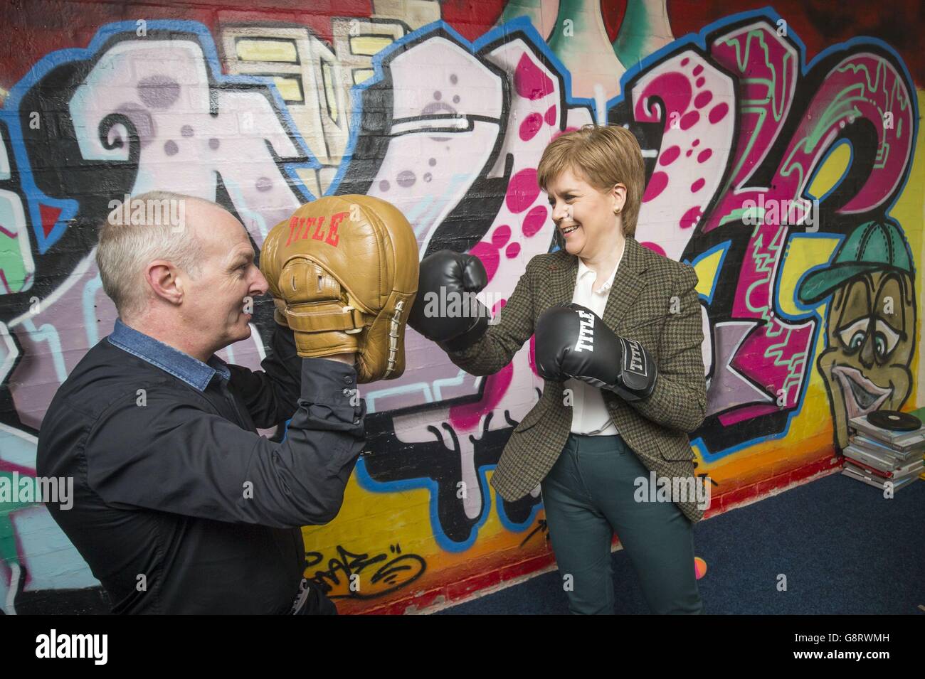 First Minister Nicola Sturgeon tries out a pair of boxing gloves as she  meets sports coach Martin O'Brien during an election campaign visit to  Glencassles Community Development Project in Wishaw, North Lanarkshire