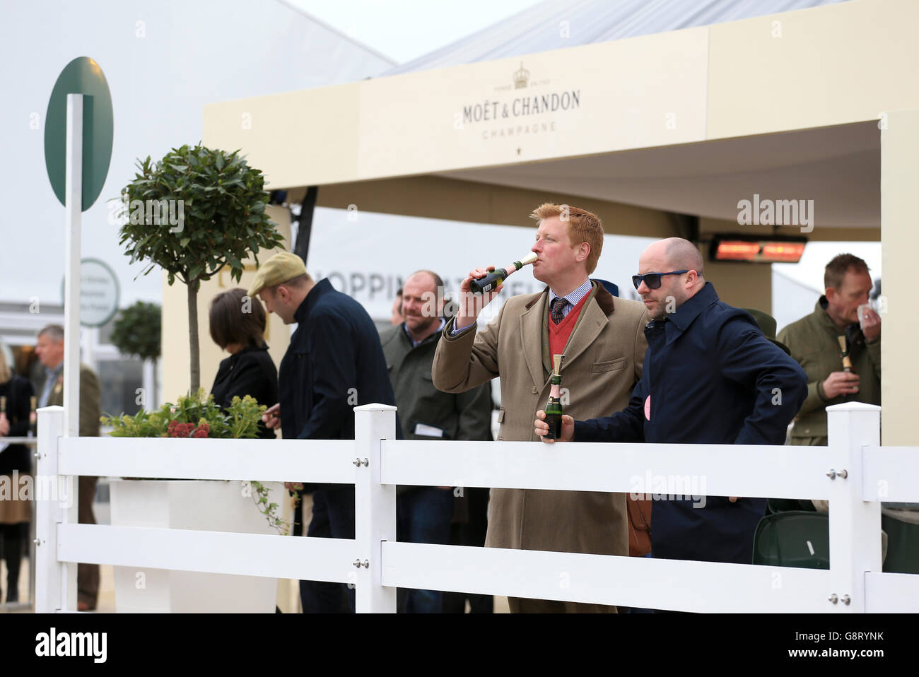 Racegoers drink Moet champagne during Champion Day at the 2016 ...