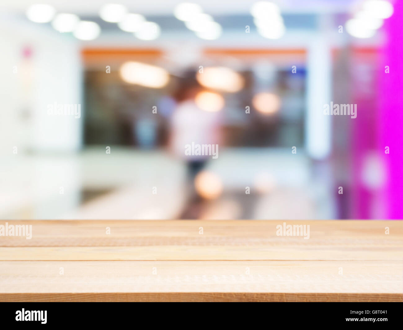 Wooden empty table in front of blurred mall Stock Photo - Alamy