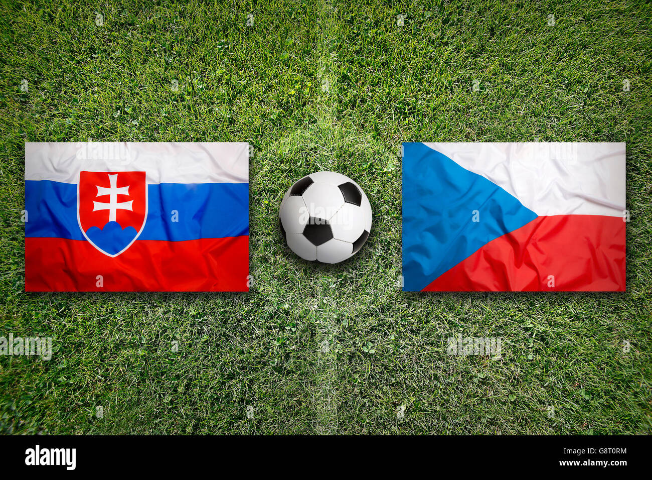 Slovakia vs. Czech Republic flags on green soccer field Stock Photo