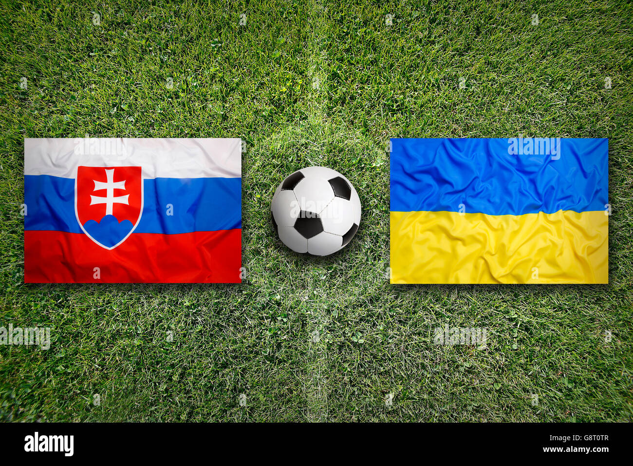 Slovakia vs. Ukraine flags on green soccer field Stock Photo - Alamy