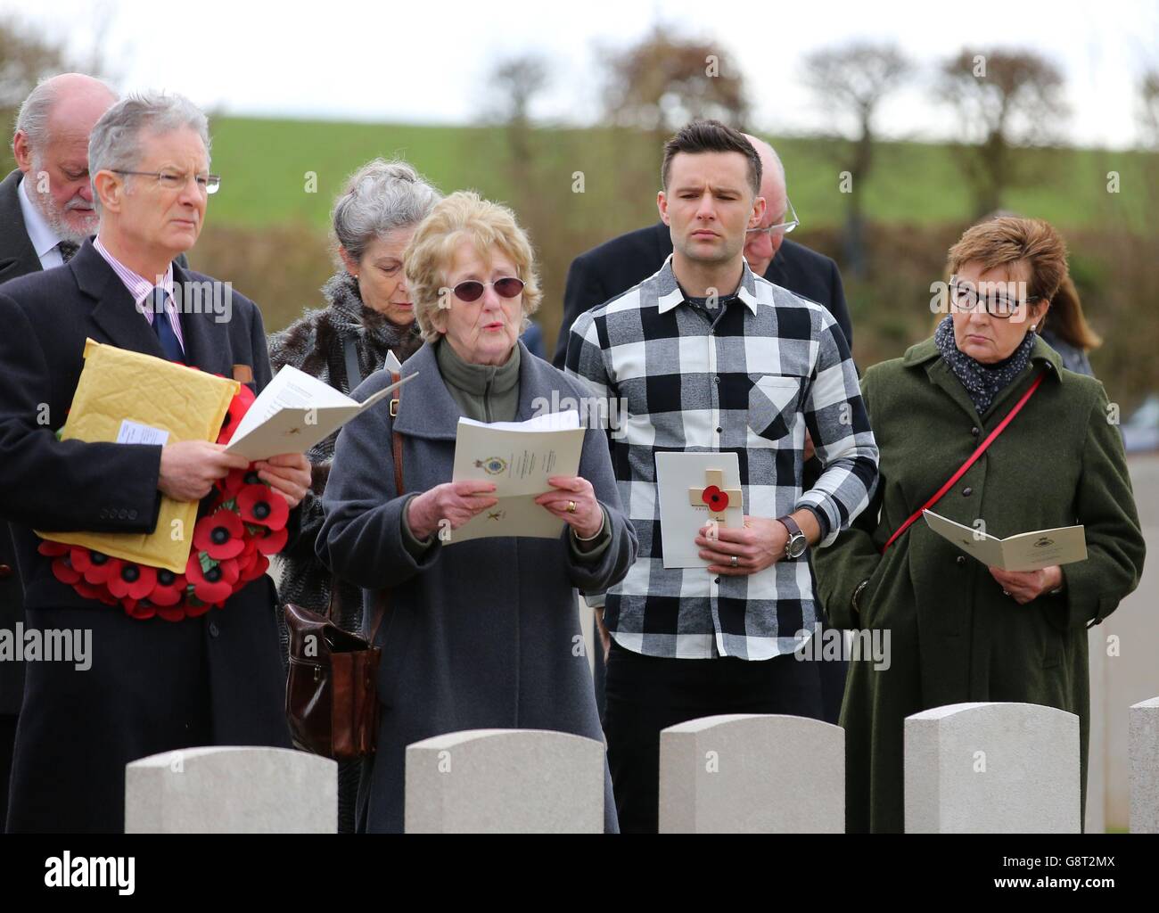 Musician Harry Judd with his father Christopher (left) aunt Selina Cohen (2nd left) and mother Emma (right) attend the rededication ceremony of his great great uncle The Reverend Alan Judd MC at the Fifteen Ravine British Cemetery in Villers-Plouich, France. Stock Photo
