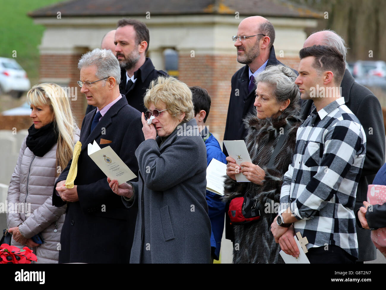 Musician Harry Judd (right) with his father Christopher (2nd left) aunt Selina Cohen (3rd left) and gathered family members attend the rededication ceremony of his great great uncle The Reverend Alan Judd MC at the Fifteen Ravine British Cemetery in Villers-Plouich, France. Stock Photo