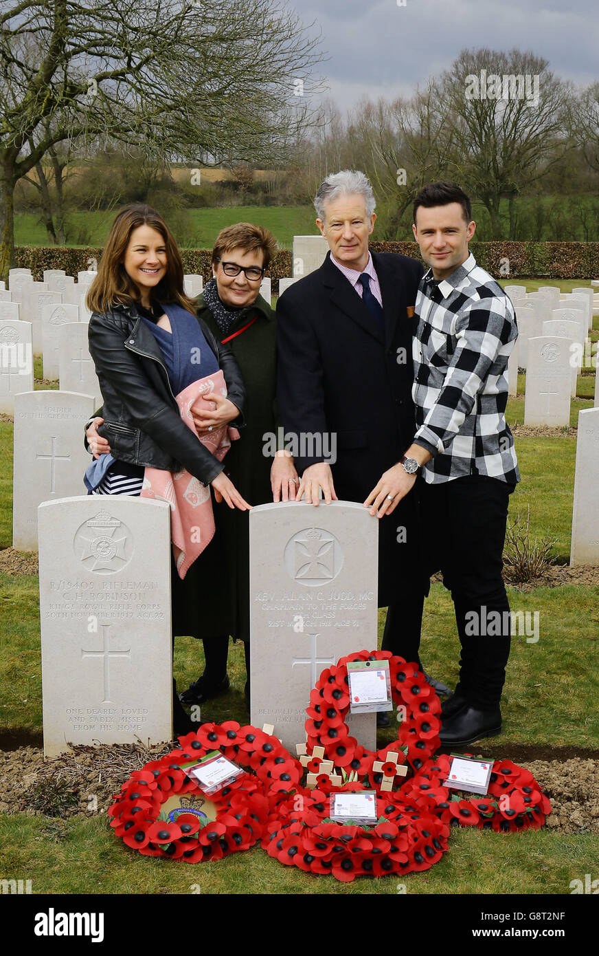 Musician Harry Judd (right) with his wife Izzy and daughter Lola (left) with his father Christopher and mother Emma pose for a family picture following the rededication ceremony of his great great uncle The Reverend Alan Judd MC at the Fifteen Ravine British Cemetery in Villers-Plouich, France. Stock Photo
