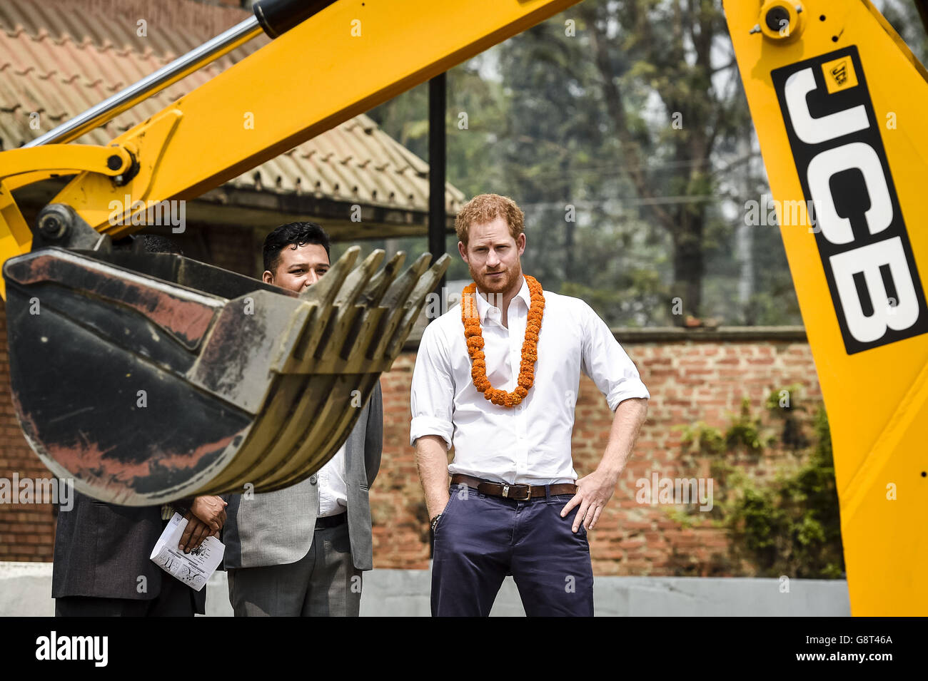 Prince Harry watches students operate a JCB tractor digger at the Samo Thimi Technical School, Bhaktapur, Nepal, which provides technical skills to underprivileged young Nepalese. Stock Photo
