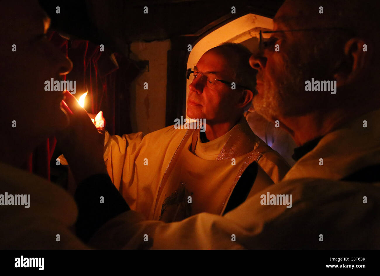 The Archbishop of Canterbury, the Most Rev Justin Welby, lights the Pachal Candle during the Easter Eve service at St. Thomas the Apostle Church in Harty, Kent, to represent the figure of the risen Christ. Stock Photo