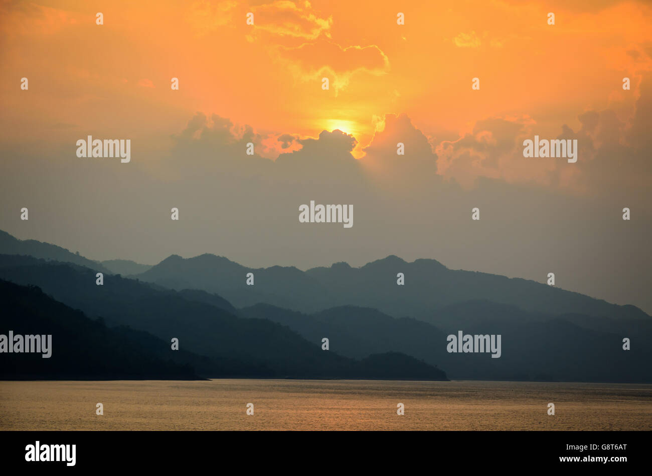 Beautiful landscape during sunset over a mountain ranges at lake in Srinakarin Dam, Kanchanaburi Province, Thailand Stock Photo