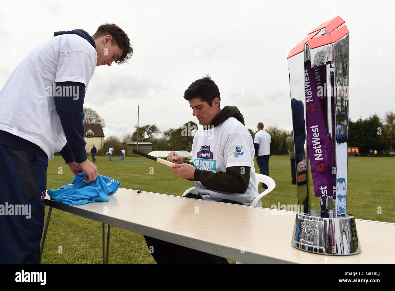 England captain Alastair Cook signs autographs during a photocall at Dymock Cricket Club in Gloucestershire. Stock Photo
