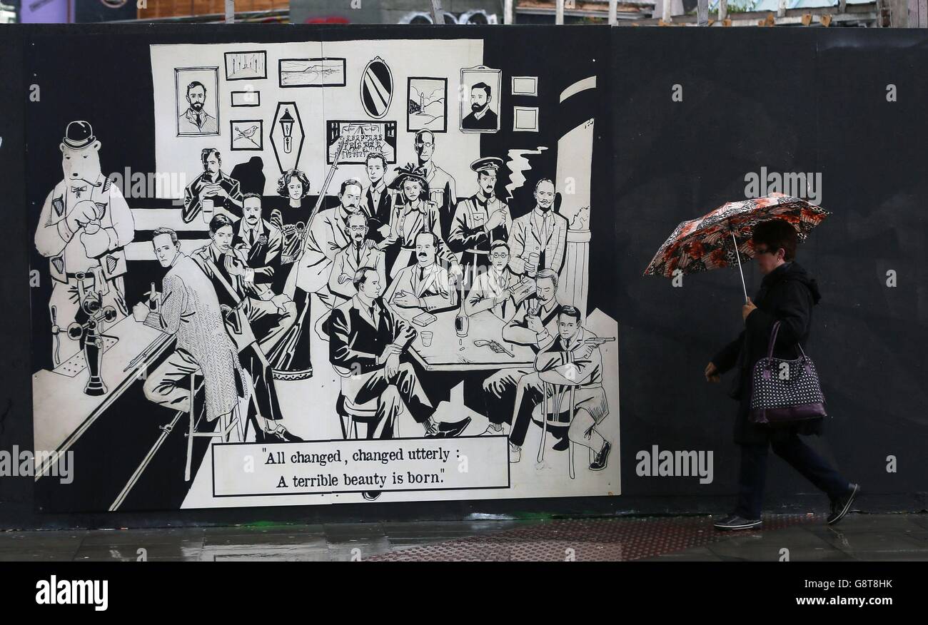 A woman passes a mural in central Dublin, where graffiti artists have ...