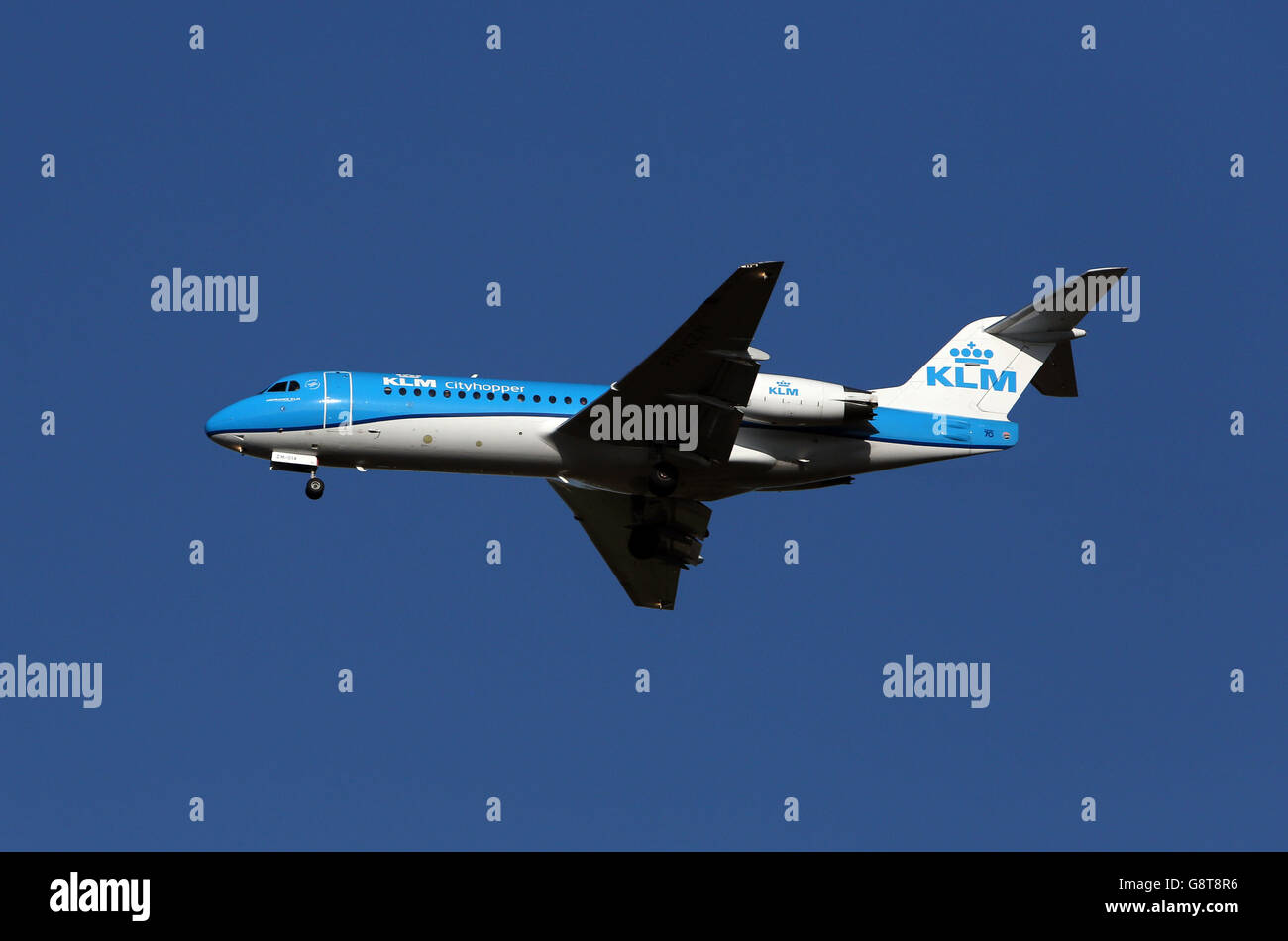 A KLM Cityhopper Fokker F70 plane with the registration PH-KZM lands at Heathrow Stock Photo