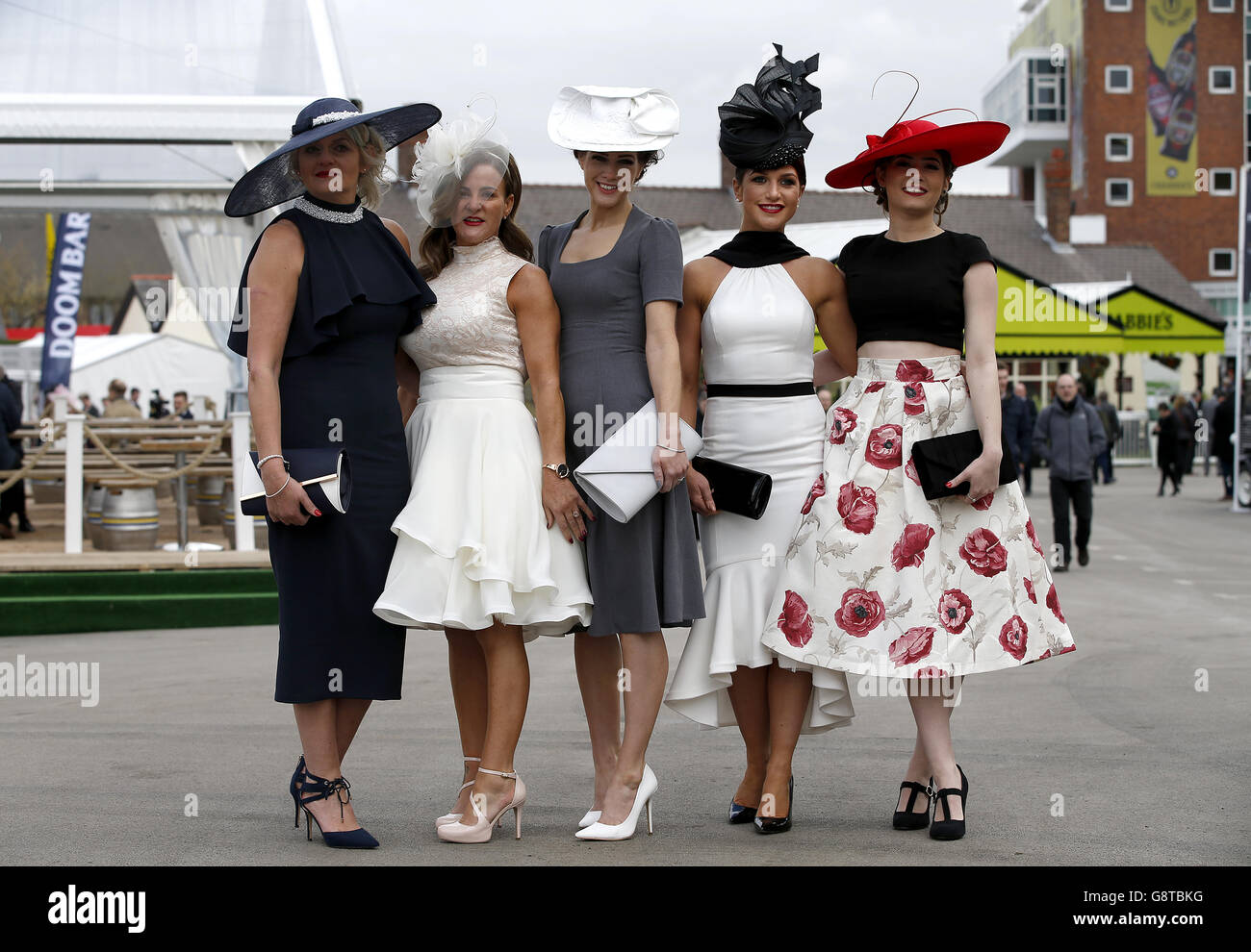 Racegoers arrive for Ladies Day of the Crabbie's Grand National Festival at Aintree Racecourse, Liverpool. Stock Photo