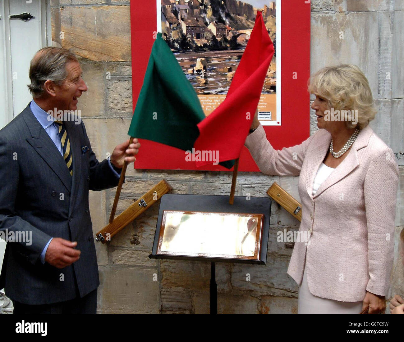 The Prince of Wales and the Duchess of Cornwall wave flags after unveiling a plaque at the old railway station in Richmond, North Yorkshire, Wednesday September 14, 2005. The Royal couple had several engagements in the town today to mark its 850th anniversary of being granted its Royal Charter. See PA story ROYAL Charles. PRESS ASSOCIATION photo. Photo credit should read: John Giles/PA/WPA Rota. Stock Photo