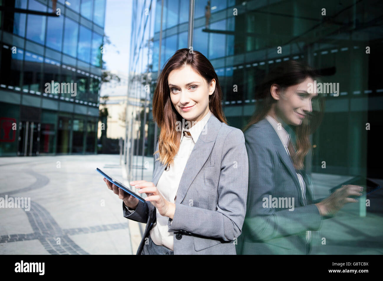Business woman using digital tablet in city Stock Photo