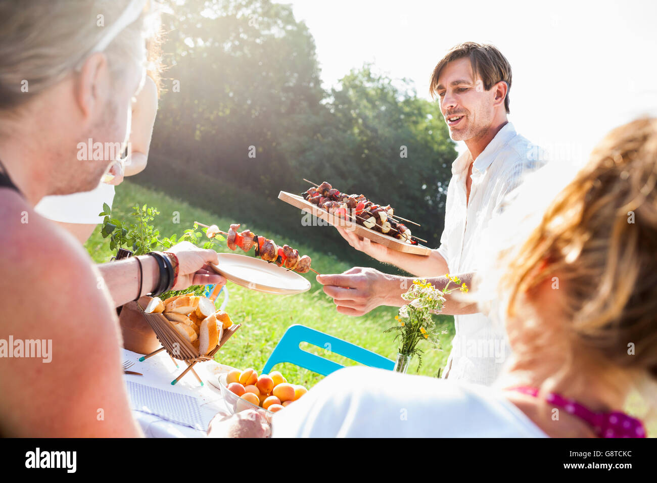 Friends barbecuing on the riverside, foothills of the Alps, Bavaria, Germany Stock Photo