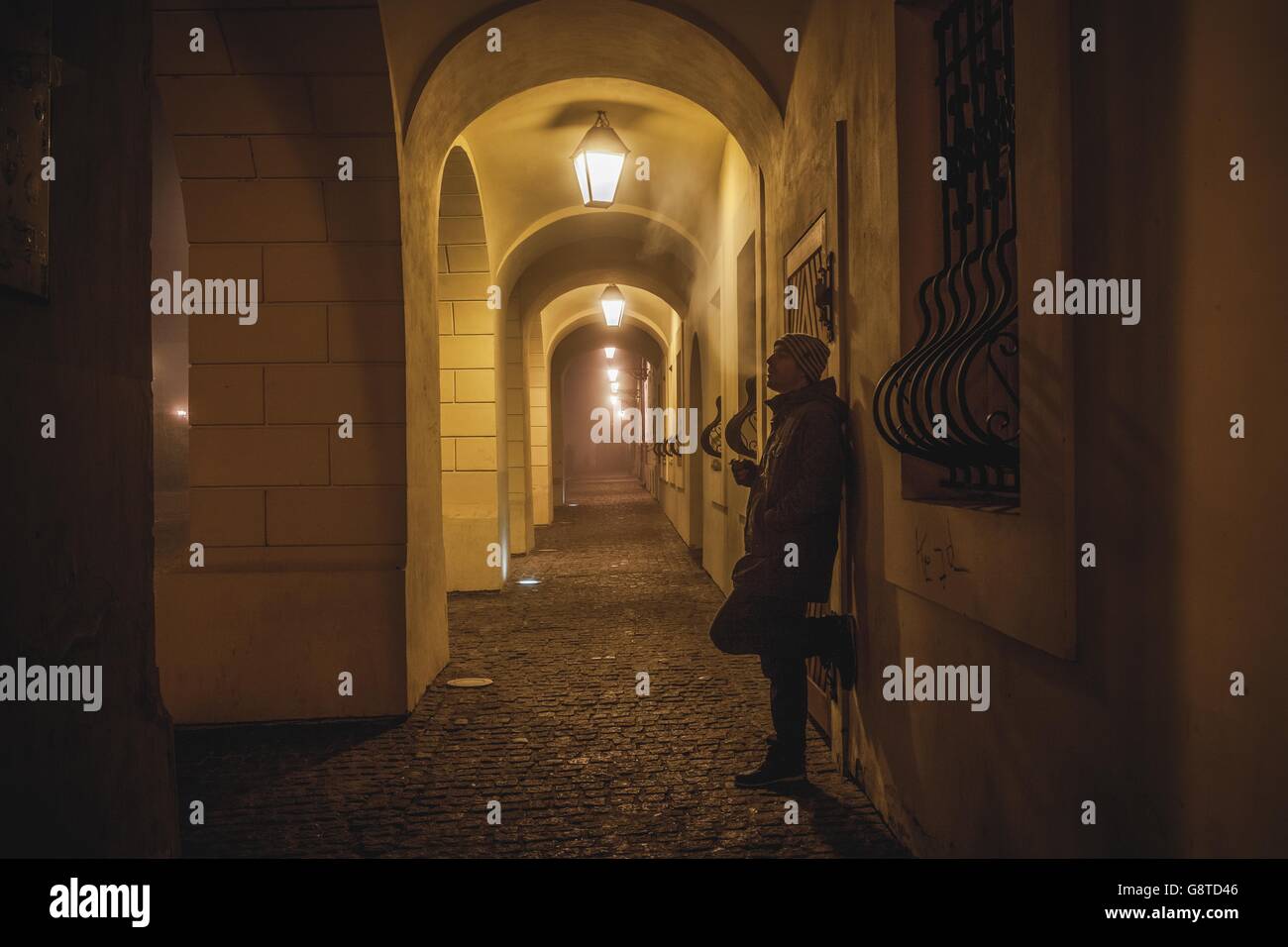 Lonely man waiting in Old Town of Osijek at night Stock Photo