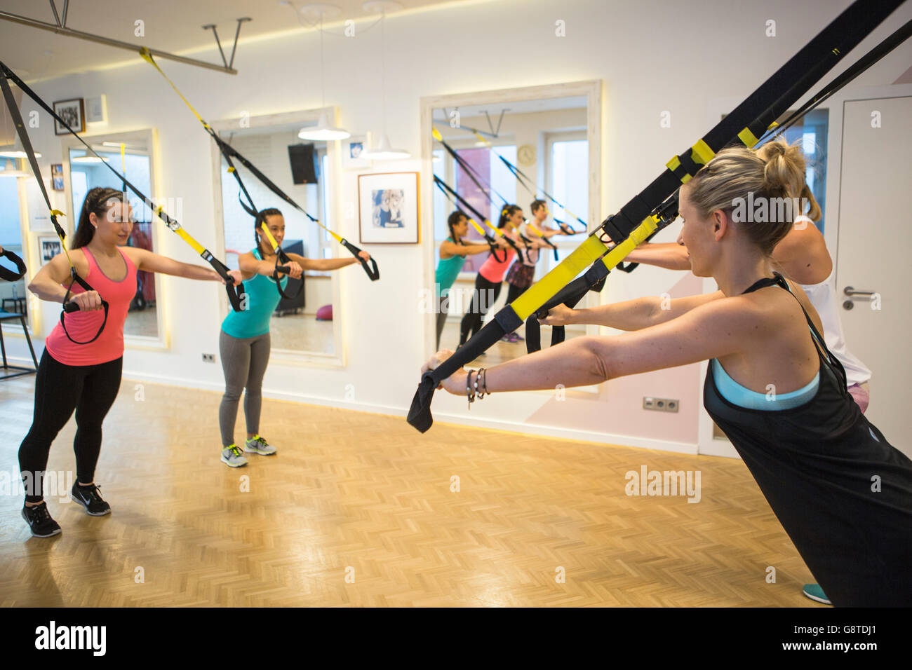 Women in exercise class doing suspension training Stock Photo