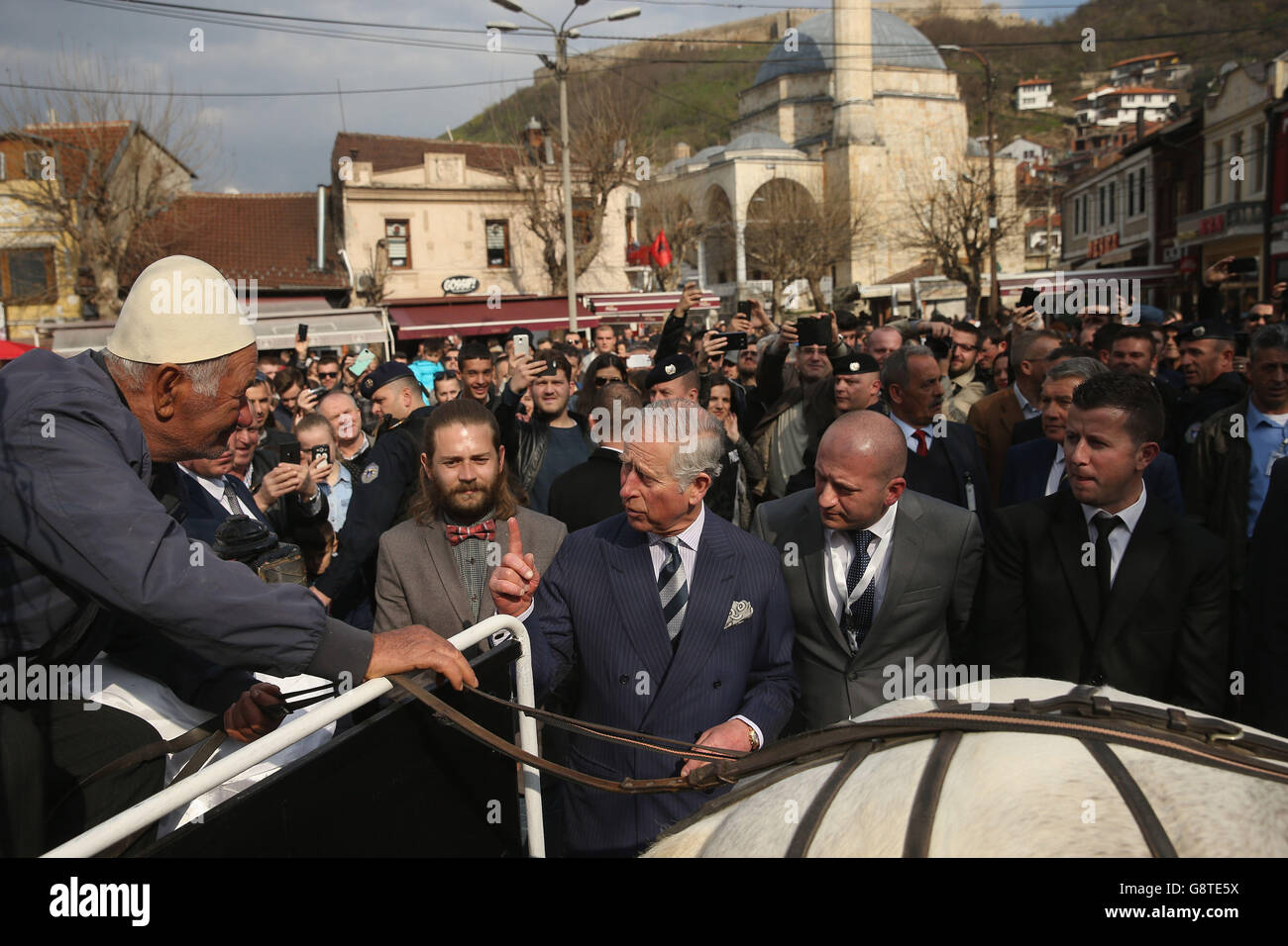 The Prince of Wales chats with the driver of a horse-drawn carriage in the old city center in Prizren, Kosovo. Stock Photo