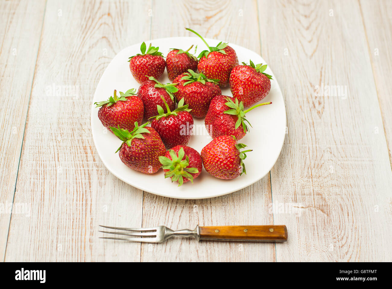 Ripe red strawberries on a white plate Stock Photo - Alamy