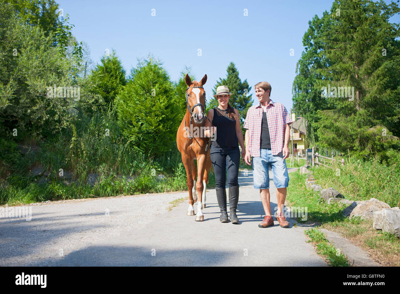 Couple with horse and pet dog in the countryside Stock Photo