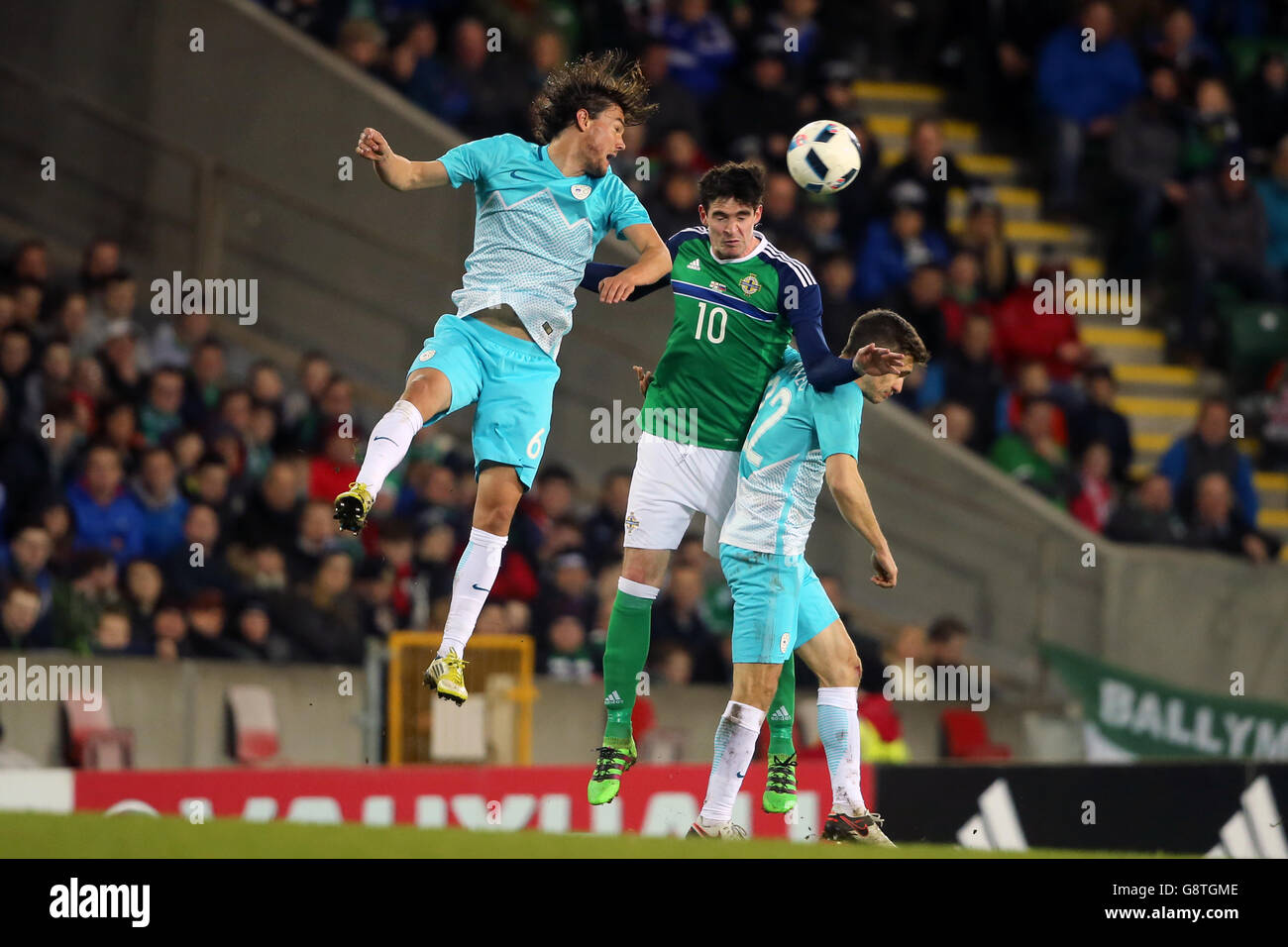 Slovenia's Krhin Rene (left) and Northern Ireland's Kyle Lafferty battle for the ball during an International Friendly at Windsor Park, Belfast. PRESS ASSOCIATION Photo. Picture date: Monday March 28, 2016. See PA story SOCCER N Ireland. Photo credit should read: Niall Carson/PA Wire. Stock Photo