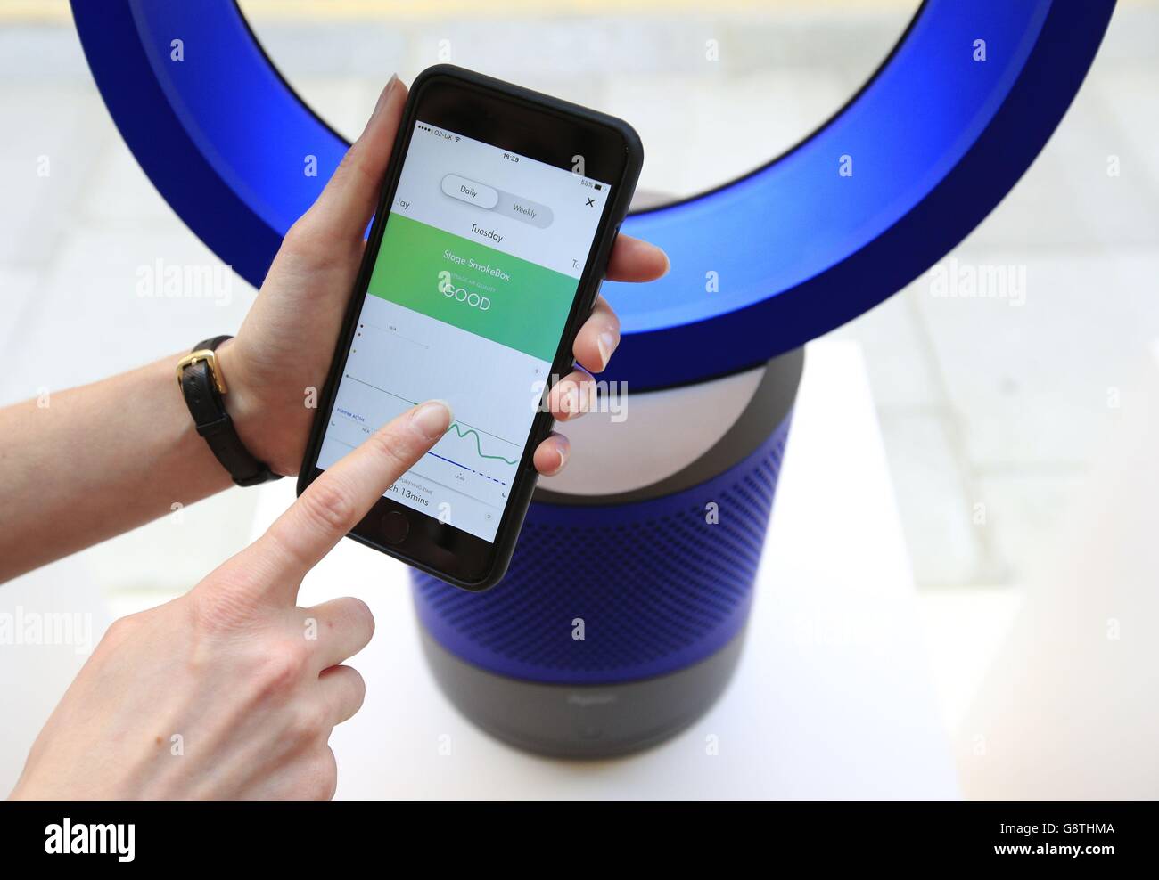 The Dyson Pure Cool Link air purifier desktop model is displayed in  conjunction with an iOS remote app for the device during an unveiling event  held at the company's shop in Kensington,