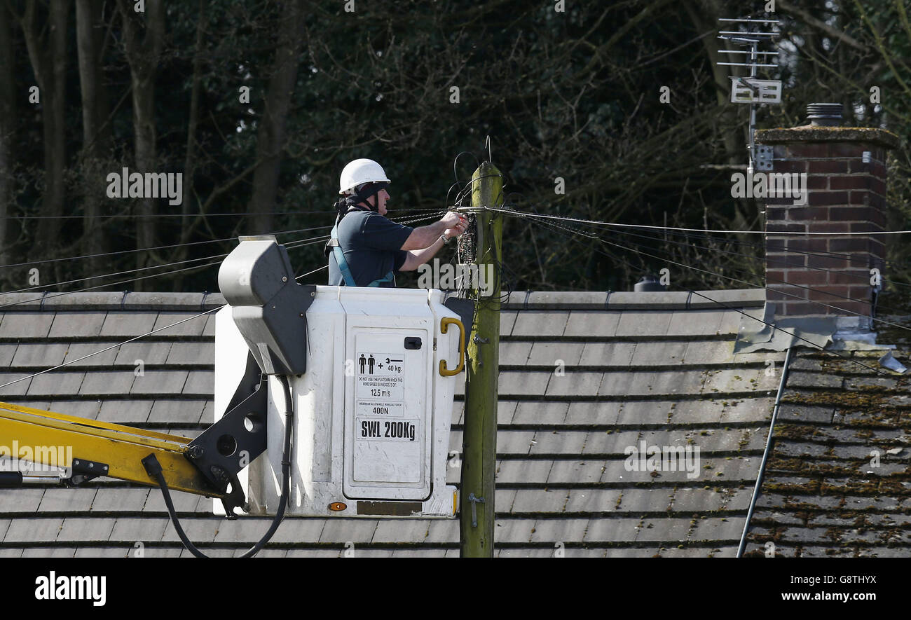 A British Telecom Openreach worker installs a new cable at a junction box on an estate in Lee Park, Liverpool. Stock Photo