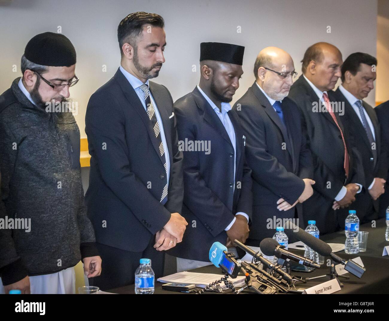 (Left to centre) Glasgow Central Mosque imam Habib ur Rehman, lawyer Aamer Anwar and Ahmed Owusu-Konadu, a member of the Ahmadiyya Muslim community, take part in a minute's silence during a press conference at Hampden Park in Glasgow to condemn the recent terror attacks around the world and death of shopkeeper Asad Shah in Glasgow. Stock Photo