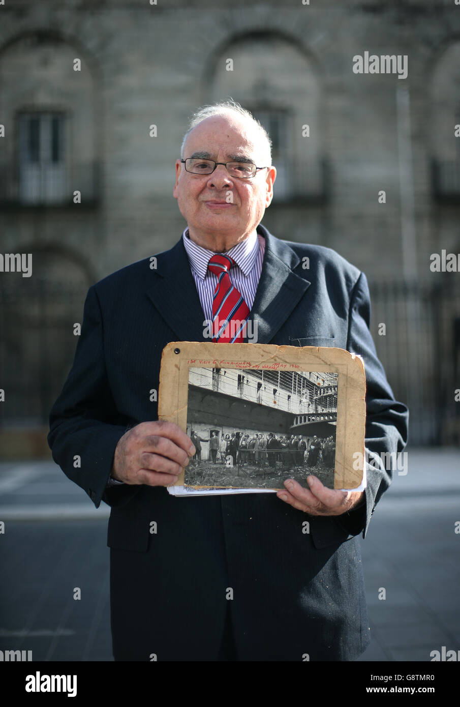 Damien Cassidy, chairman of the board of visitors in Kilmainham and one of the original trustees of the Kilmainham Gaol Restoration Committee set up in 1960, holds a photograph showing the voluntary workers' first visit to the gaol in May 1960, as he attends a special event in Dublin, Ireland, held to honour the Kilmainham Gaol Restoration Society, the volunteer group which saved the historic prison from dereliction in the 1960s. Stock Photo