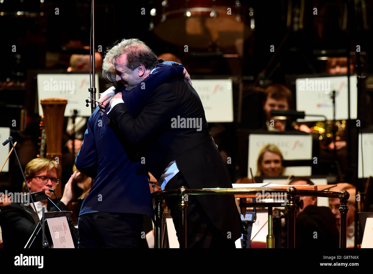 Clarinettist Martin Frost is greeted by conductor Jaime Martin during Classic FM Live at the Royal Albert Hall, London. Stock Photo