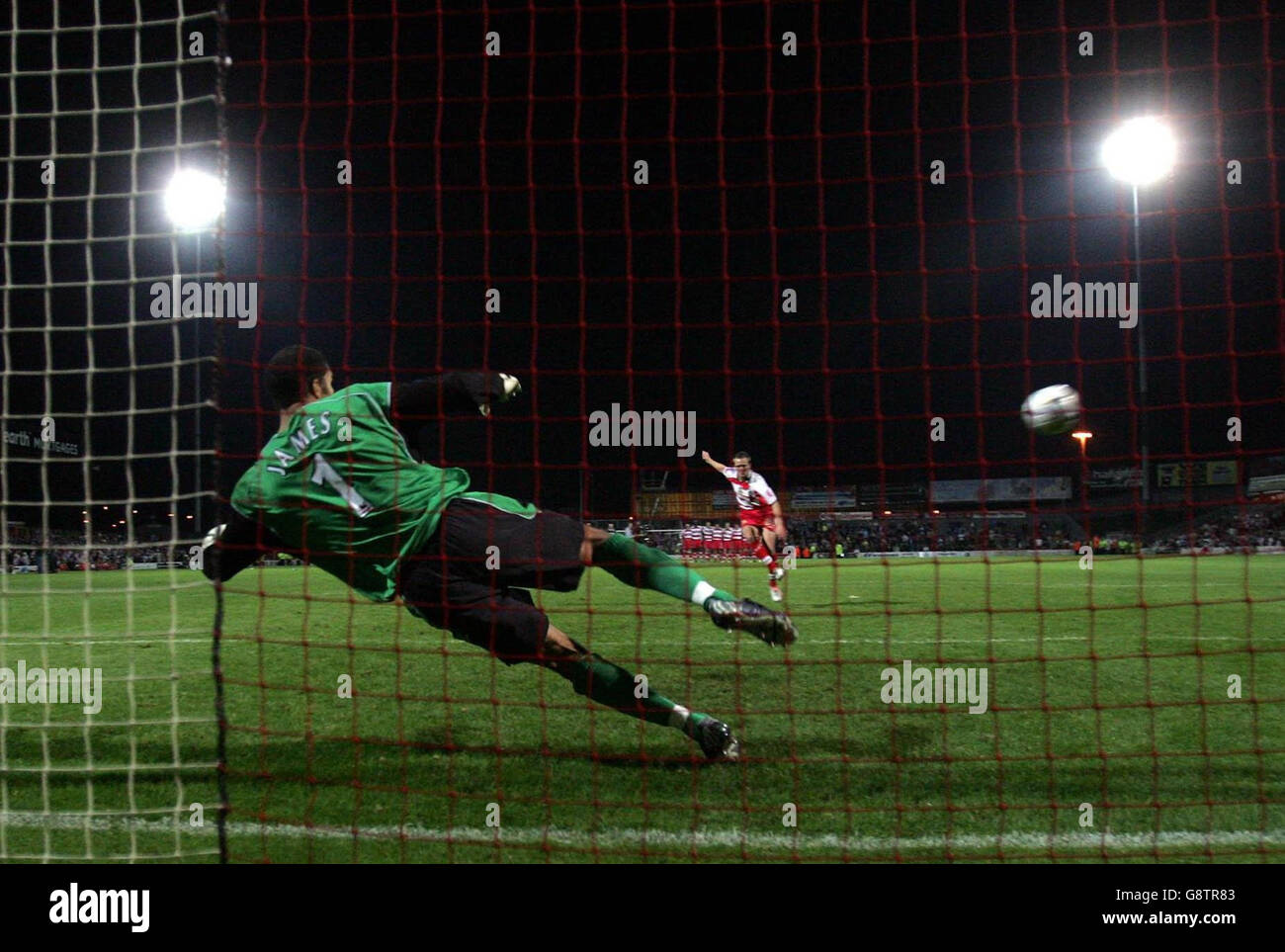 Manchester City's goal keeper David James (L) lets in a goal from Doncaster Rovers' James Coppinger during the penalty shoot-out in the Carling Cup second round match at The Earth Stadium, Doncaster. Stock Photo
