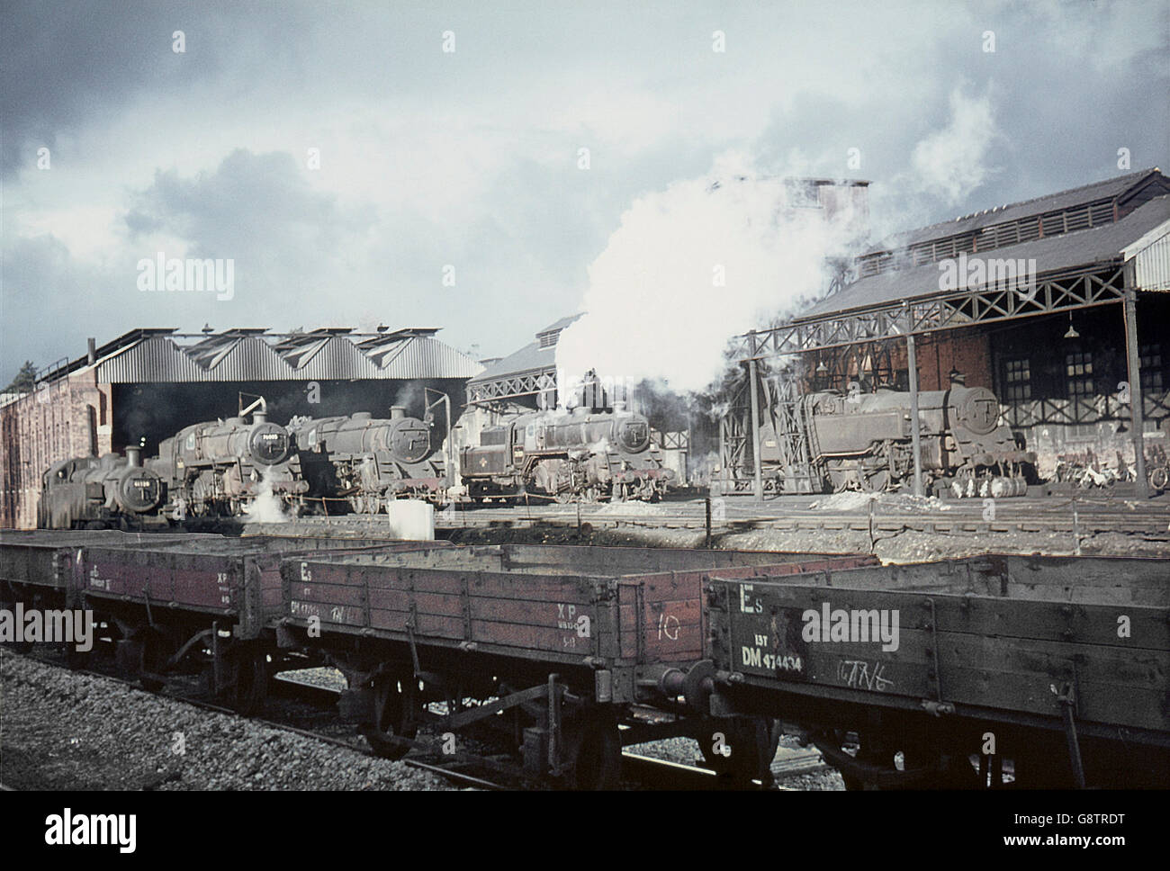 A line up of BR standard designs on Bournemouth motive power depot with an ex-LMS Ivatt 2-6-2T passing. Stock Photo