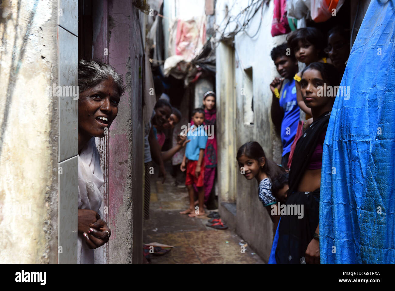 Women look out from their homes in a slum in the Ambedkar Nagar district of Mumbai, India. Stock Photo
