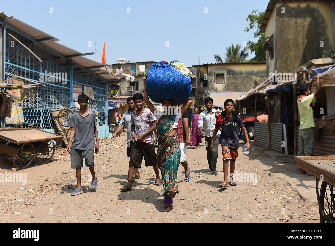 People walk through the Ambedkar Nagar district of Mumbai, India. Stock Photo
