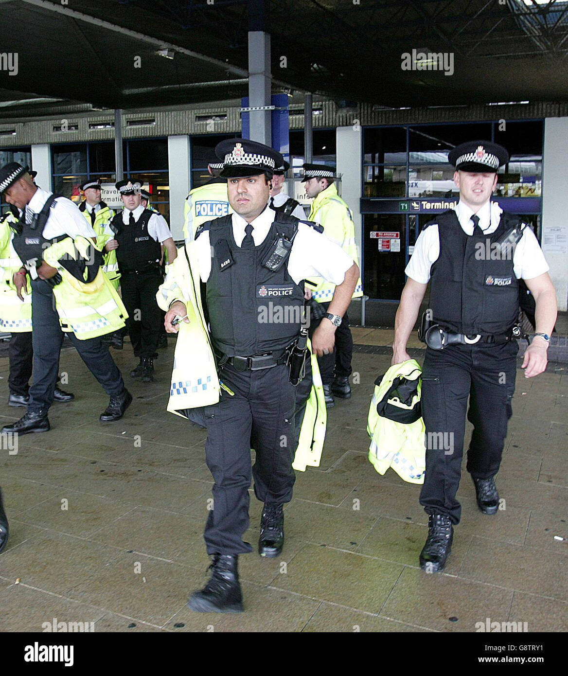 Police stand outside Terminal 1 of Manchester Airport, Friday September