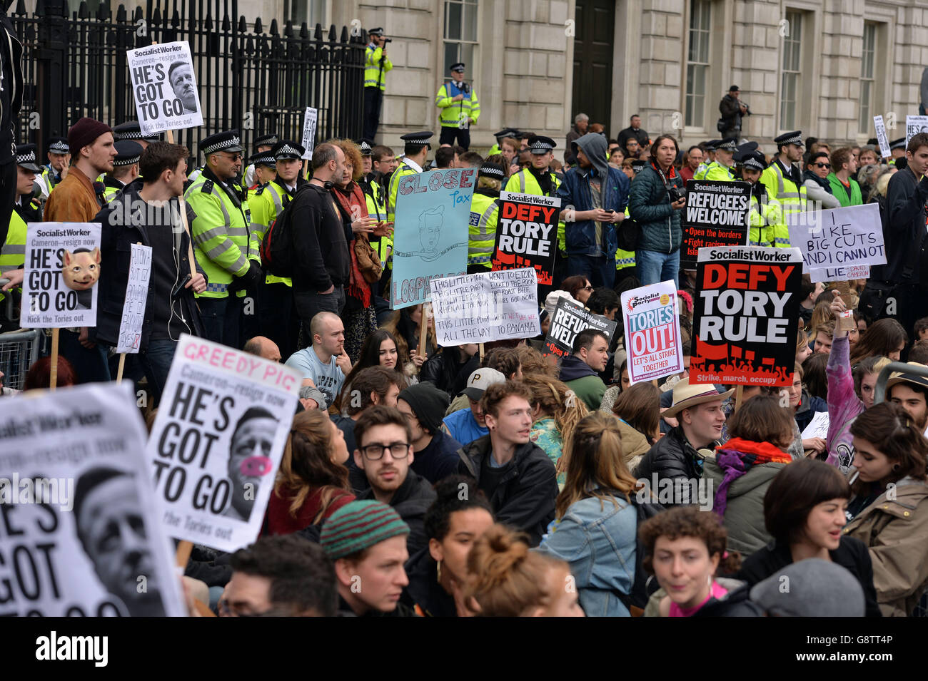 EDITORS NOTE LANGUAGE ON BANNER Protesters gather outside the gates of Downing Street in London to call for the resignation of Prime Minister David Cameron in the wake of the Mossack Fonseca data leak. Stock Photo