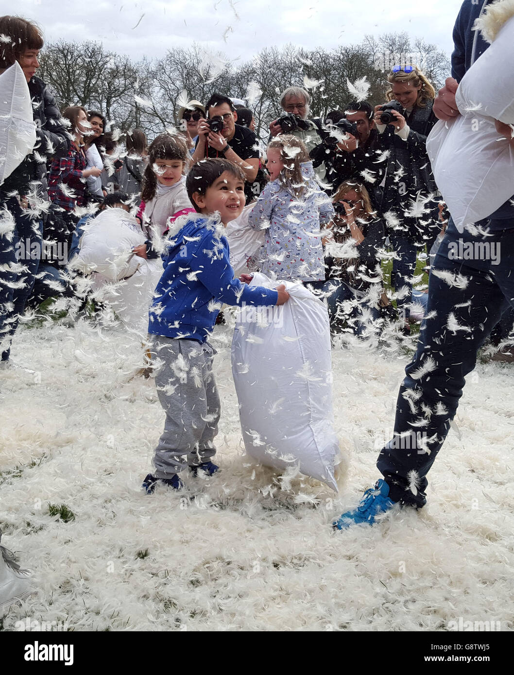 People take part in a mass pillow fight in Kennington park in London, to mark International Pillow Fight Day. Stock Photo