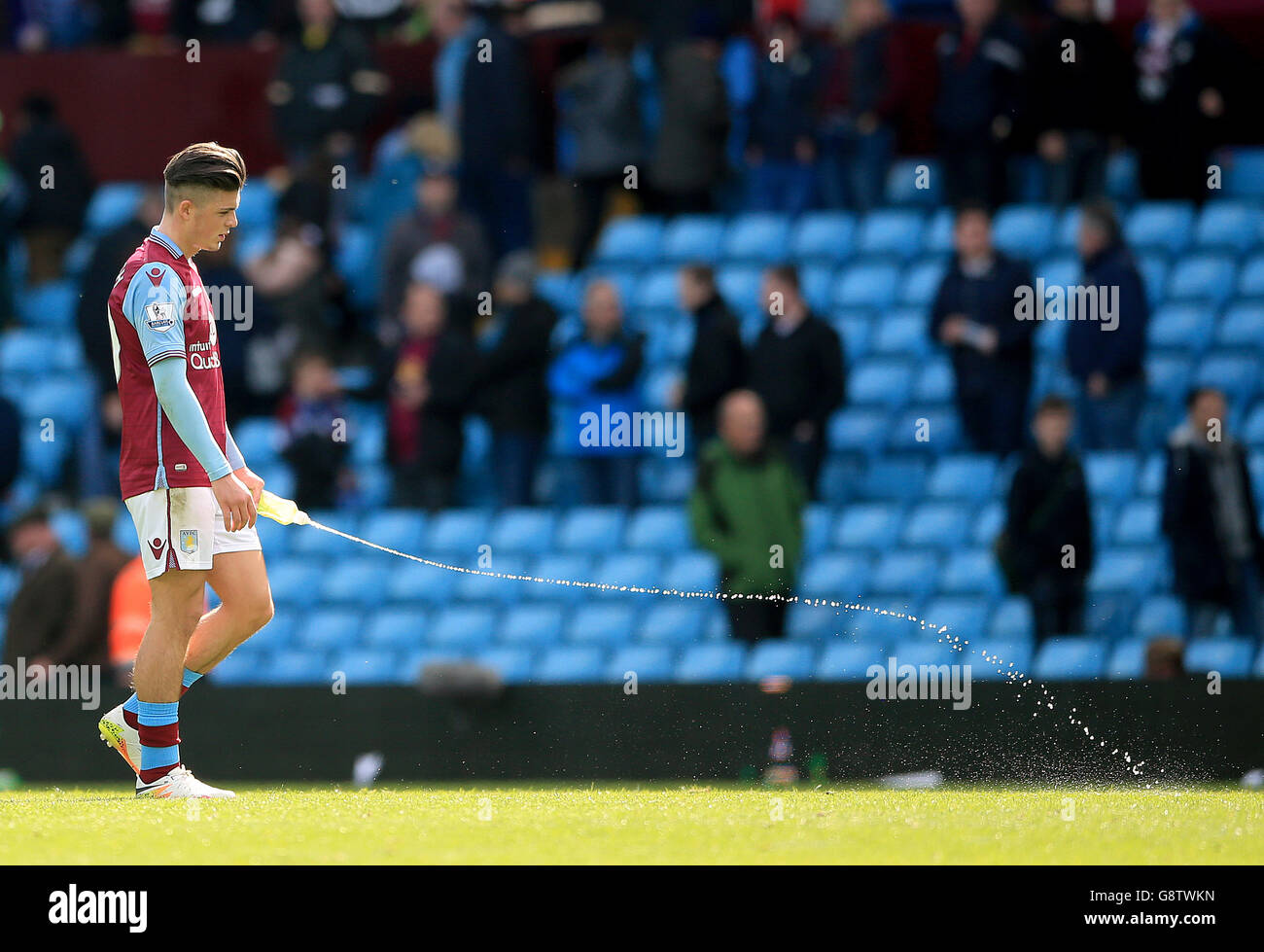 Aston Villa's Jack Grealish squirts his water bottle in frustration after the Barclays Premier League match at Villa Park, Birmingham. Stock Photo