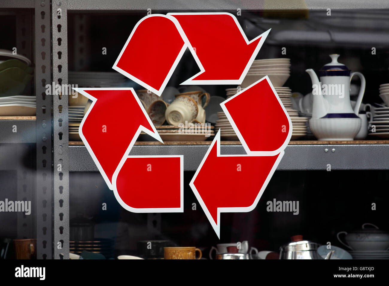 Recycling sign in the window of a shop selling secondhand goods. Stock Photo