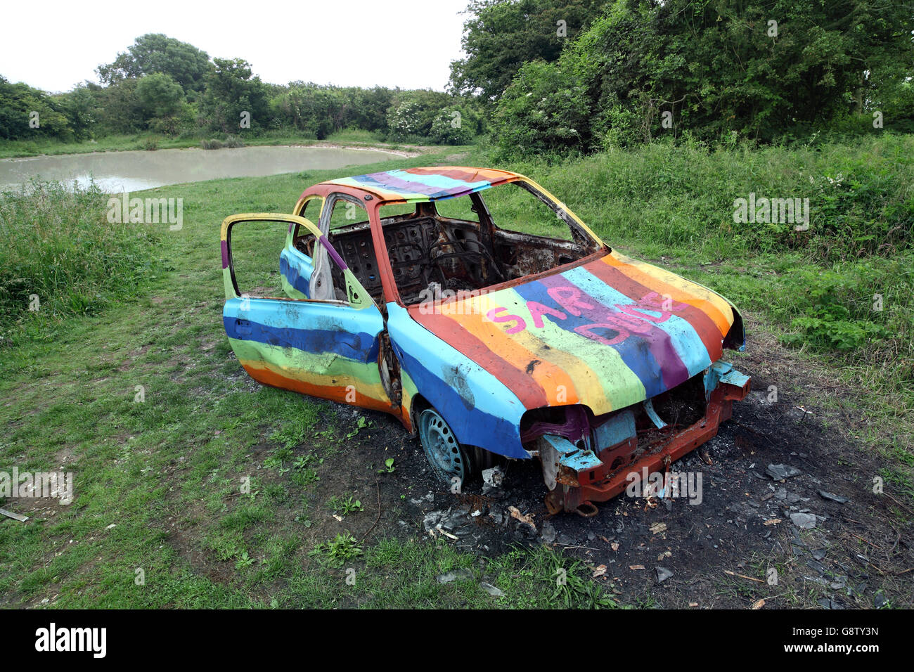 Abandoned and burned out car on the Downs near Brighton. Stock Photo