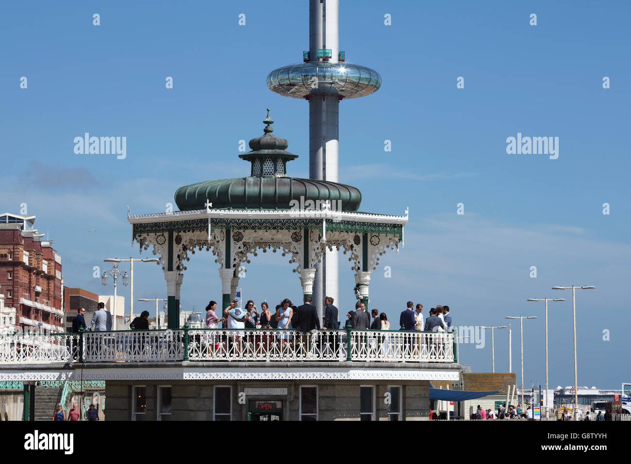 Old and new attractions on Brigton seafront: the old bandstand (with party!) and the new i360 moving observation tower Stock Photo