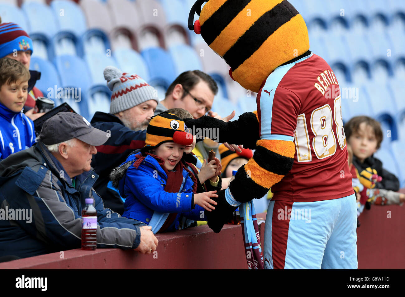 Burnley mascot Burnley Bee greets young fans before the game Stock Photo