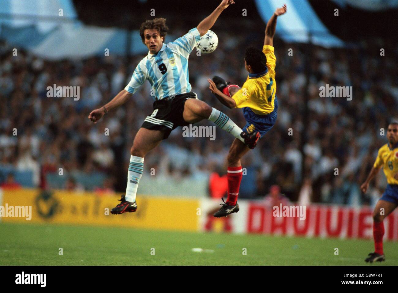 Gabriel Batistuta of Argentina (left) jumps for the ball Stock Photo