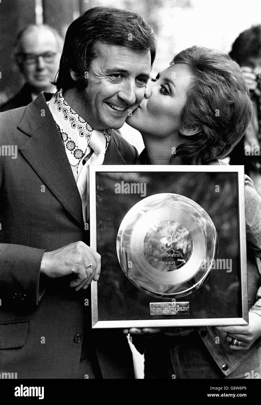 Tony Christie, 29, gets a kiss of congratulations from pop star Lulu as she presents him with his first Gold disc. Stock Photo