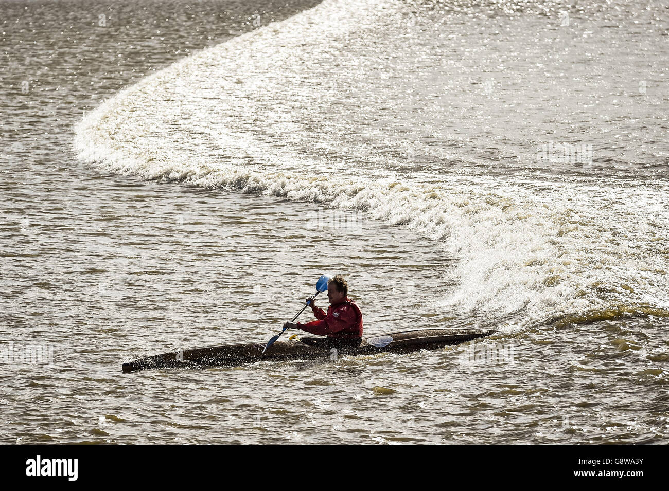 A kayaker catches the Severn Bore wave at Newnham, Gloucestershire, as the 4-star rated tidal bore passes up the Severn Estuary. Stock Photo