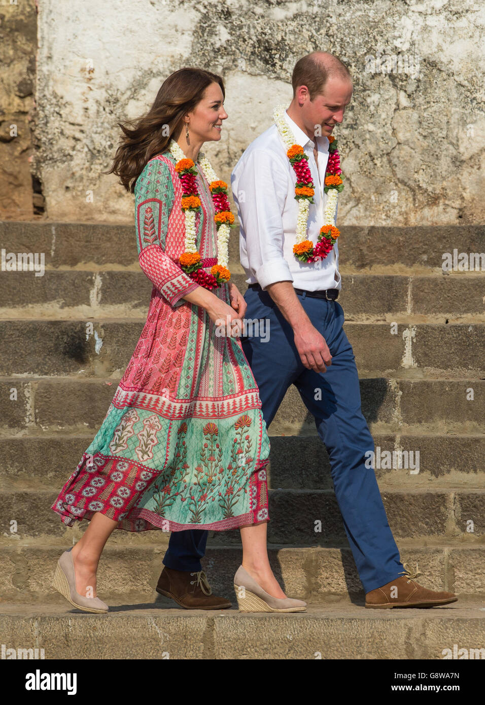 The Duke and Duchess of Cambridge wear floral garlands during a visit