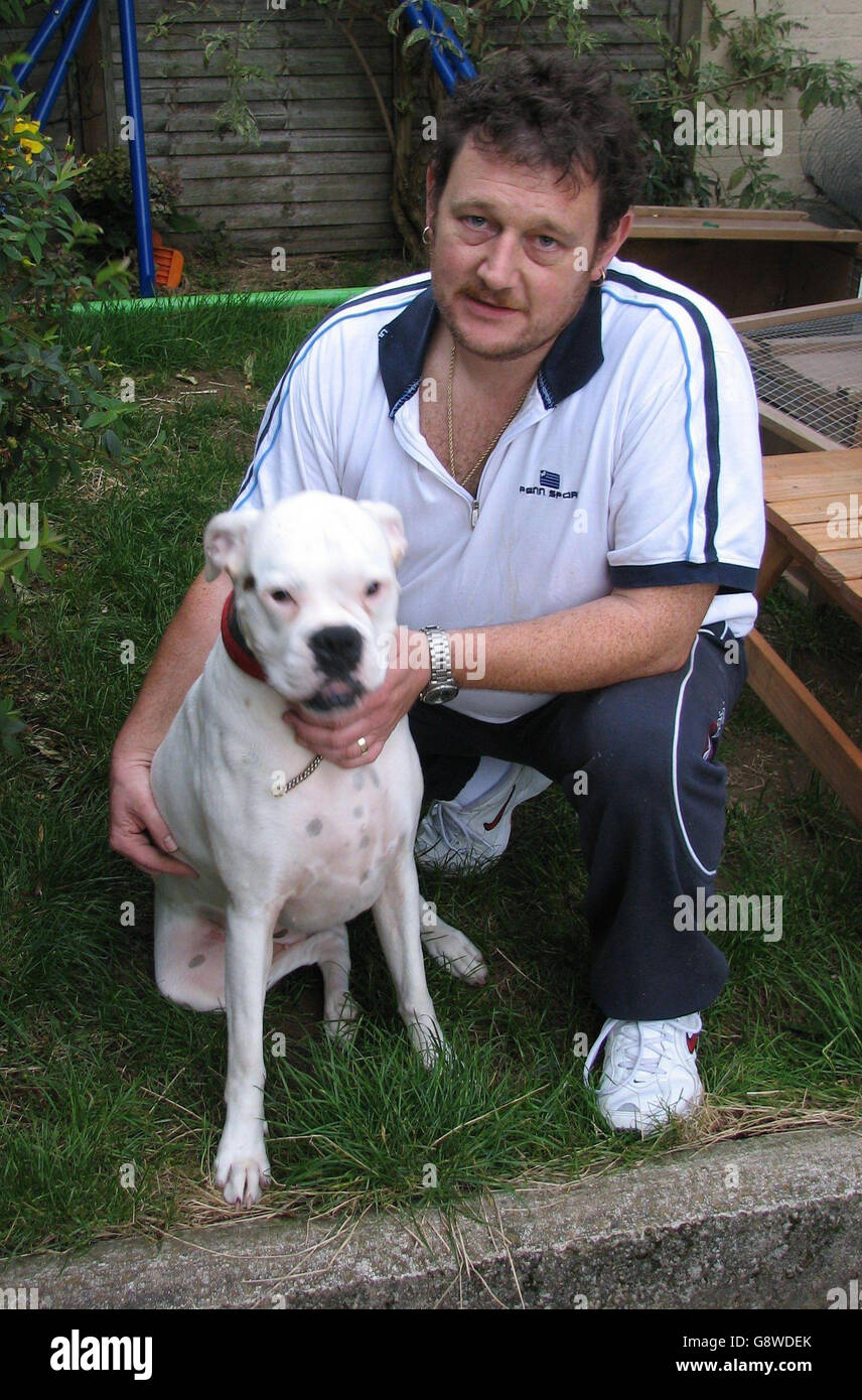Dave Tucker, 43, from Plymouth, and his three-year-old boxer dog Ruby, which set in motion a trail of destruction after leaping into the family car and knocking off the handbrake, Monday September 26, 2005. See PA story ANIMALS Dog. PRESS ASSOCIATION Photo. Photo credit should read: Sam Marsden/PA Stock Photo