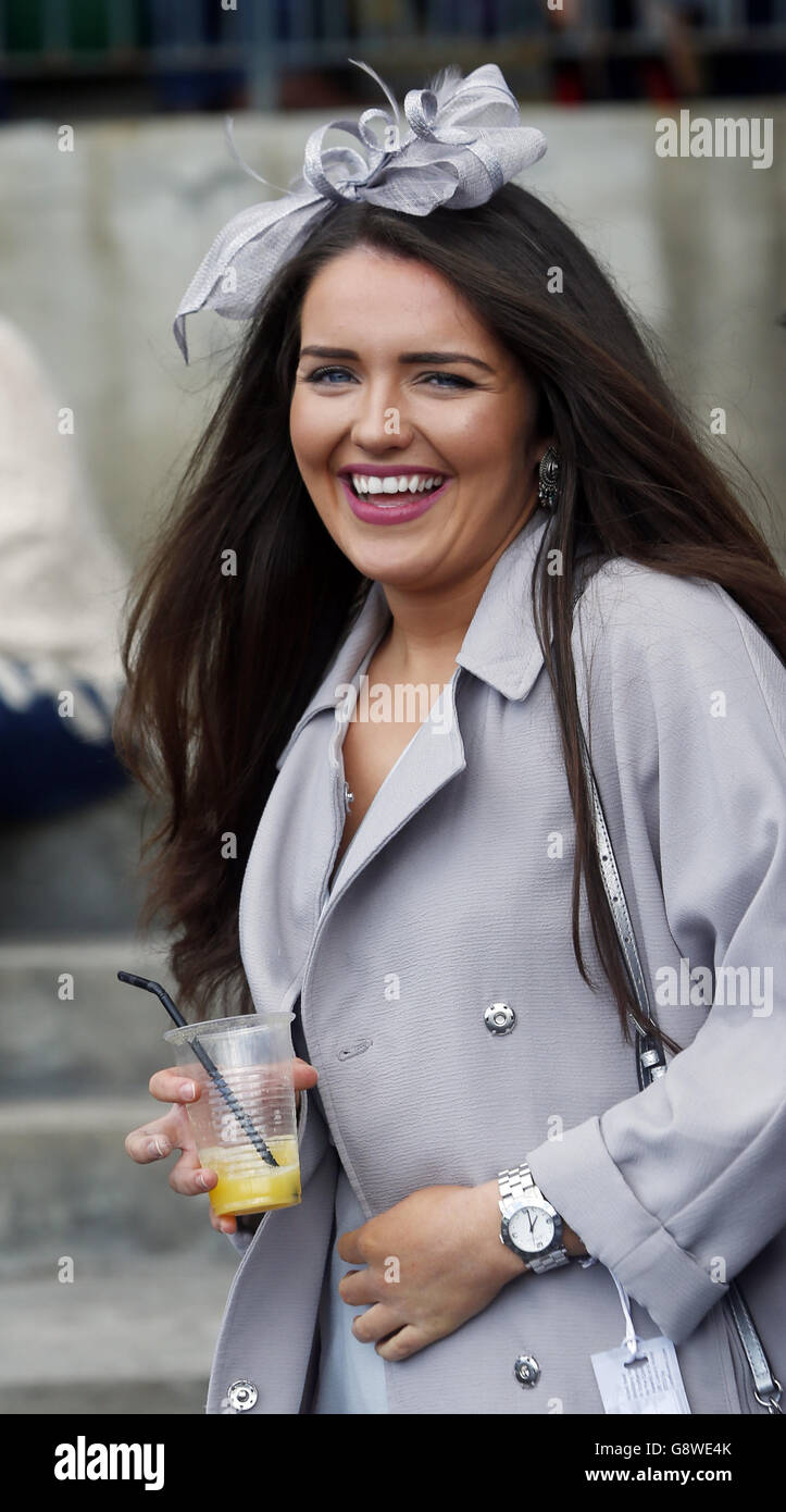 A woman enjoys the day during Scottish Grand National Day at the Coral Scottish Grand National Festival at Ayr Racecourse. Stock Photo