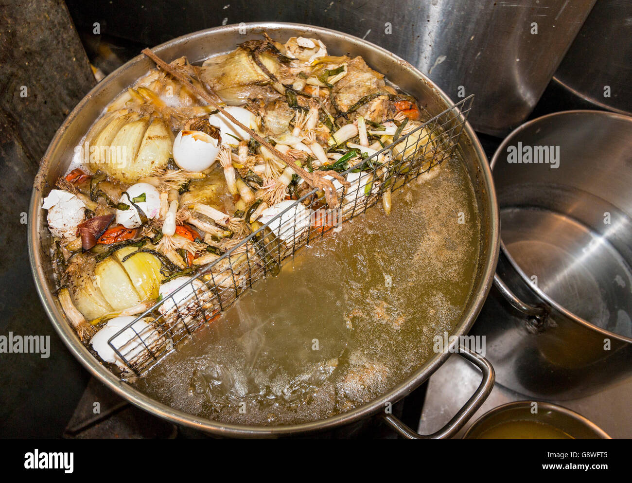 Chef's broth, made from just about anything and here including onions, egg shells, tomatoes, bits of meat. Stock Photo